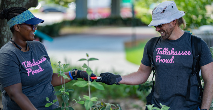 two workers enjoying their jobs in a garden